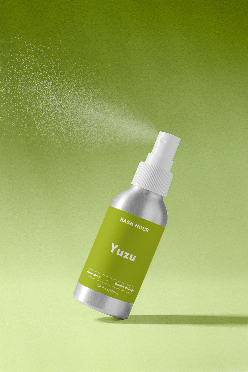 Yuzu linen spray bottle with green label on a green background.