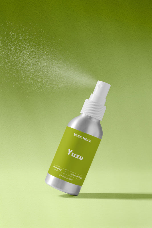 Yuzu linen spray bottle with green label on a green background.