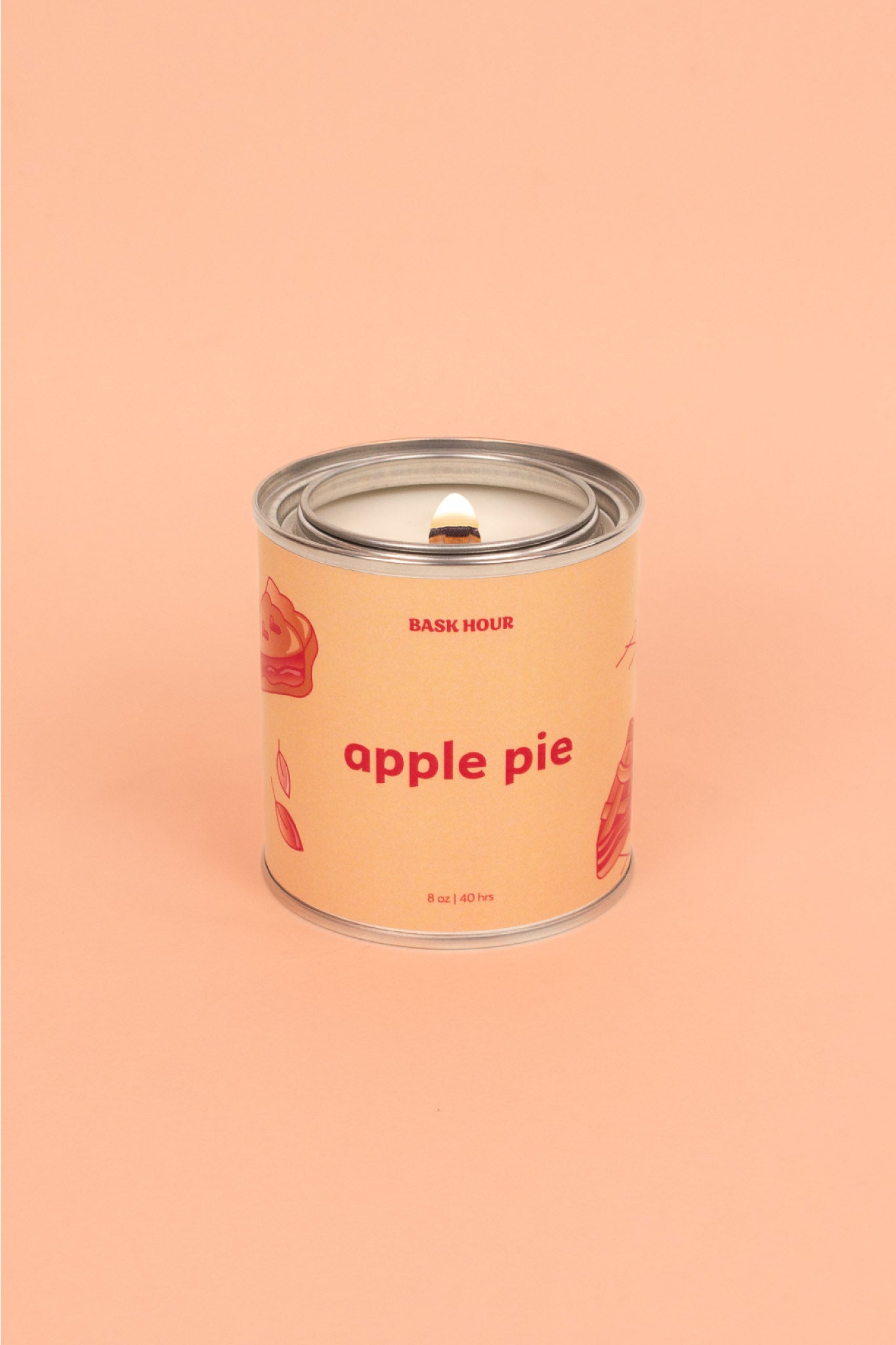 A natural, toxin-free apple pie scented candle in a simple glass jar. The candle features a smooth wax surface with a warm, golden hue. A single cotton wick is centered, and the label highlights its all-natural ingredients and comforting apple pie aroma.