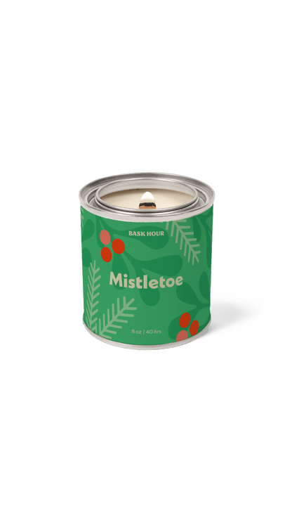 Candle in a green container labeled 'Mistletoe' on a green background