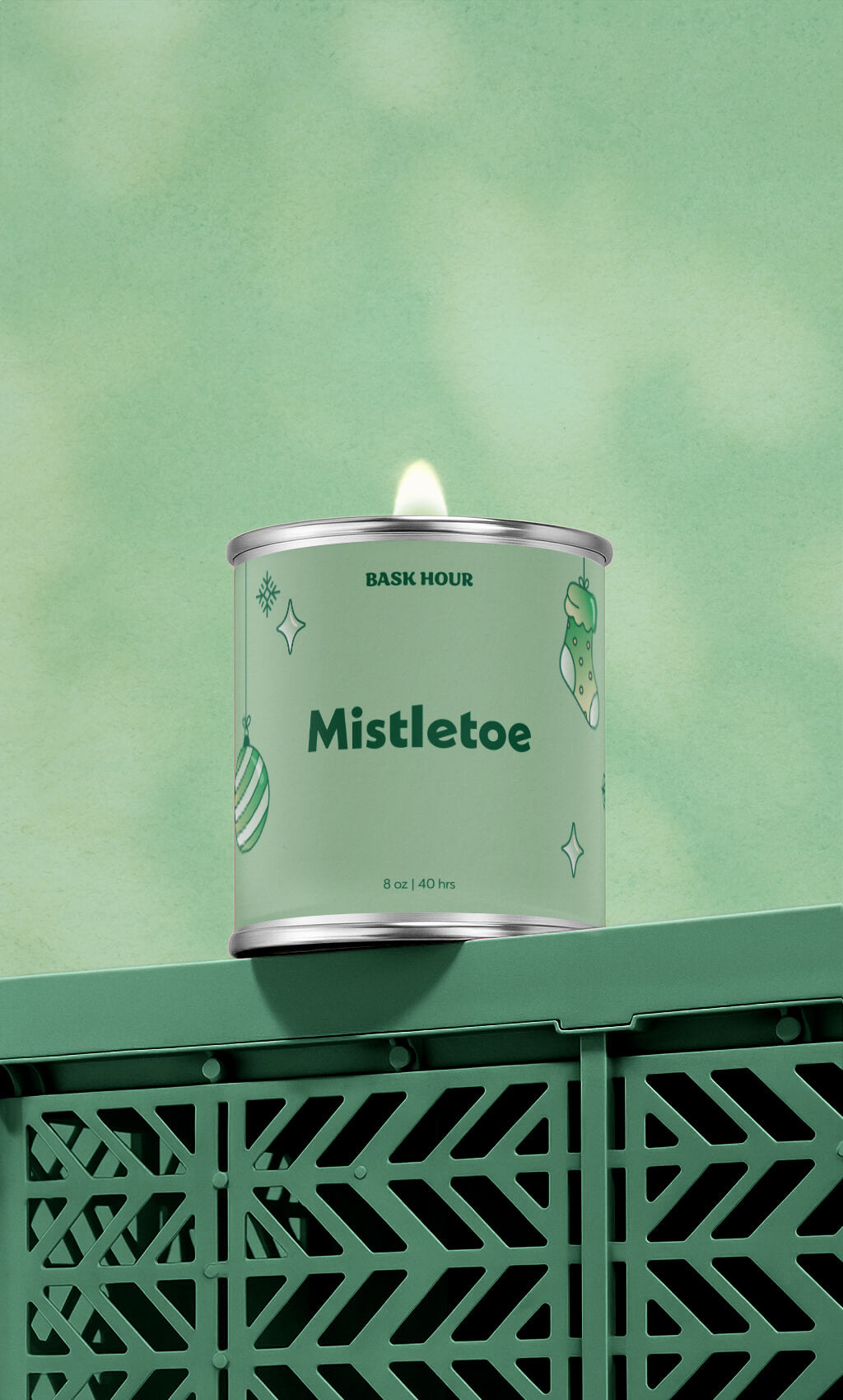 Candle in a green container labeled 'Mistletoe' on a green background