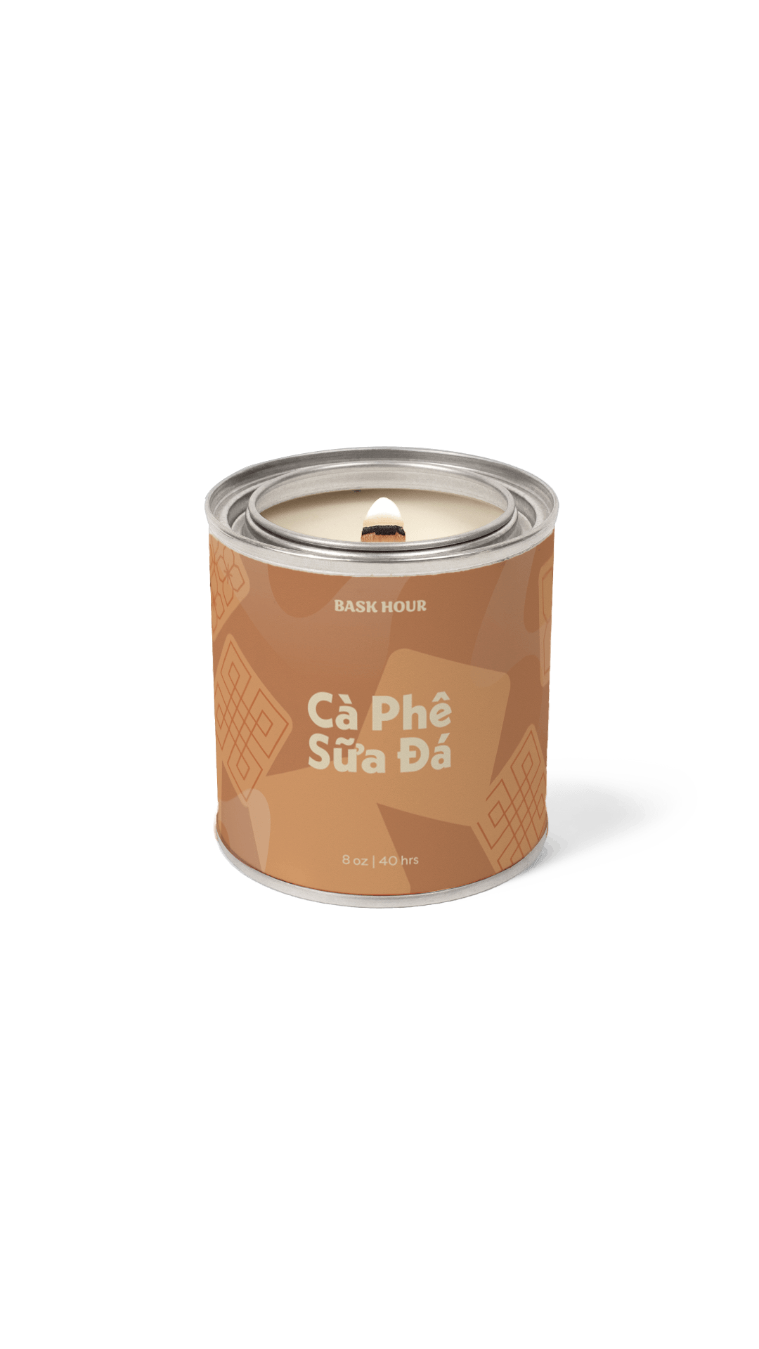 A single cylindrical candle tin on a plain white background. The tin is brown with lighter brown chocolate chip illustrations and white text reading 'BASK HOUR' and 'Câ Phé Sùra Dá'.